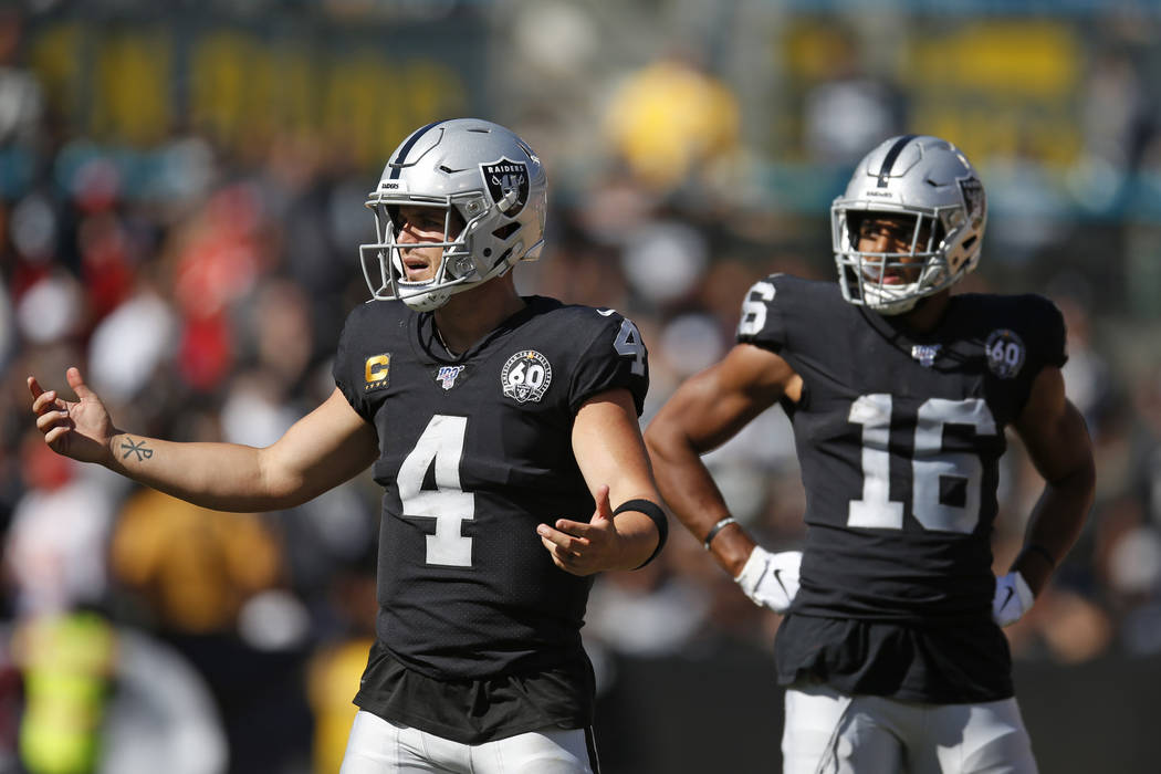 Oakland Raiders quarterback Derek Carr (4) reacts after a play as wide receiver Tyrell Williams ...