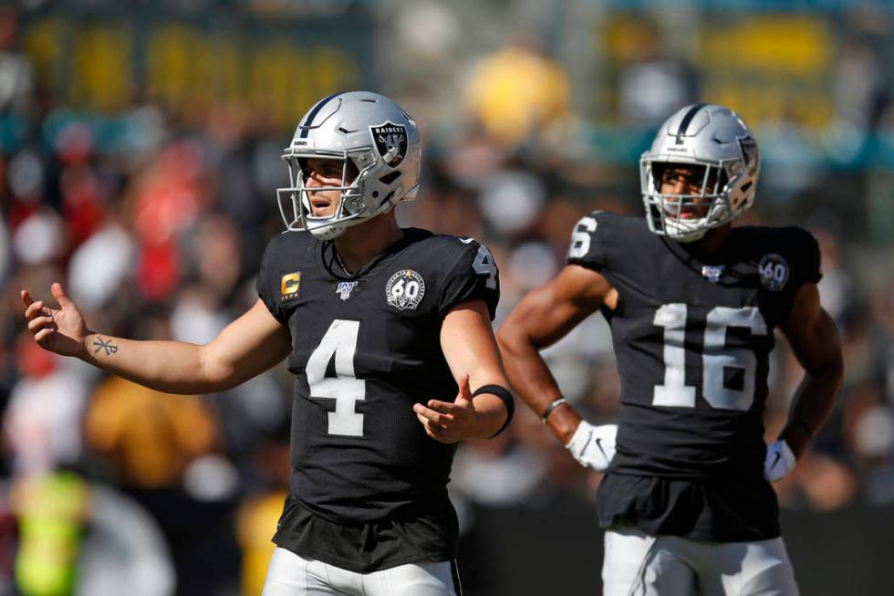 Oakland Raiders quarterback Derek Carr (4) reacts after a play as wide receiver Tyrell Williams ...