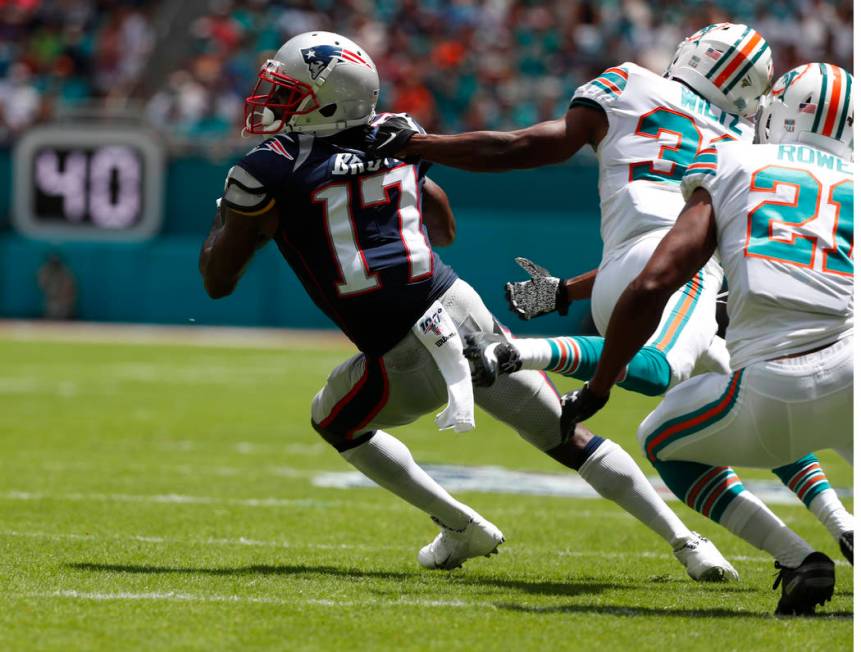 New England Patriots wide receiver Antonio Brown (17) gets away from Miami Dolphins cornerbacks ...