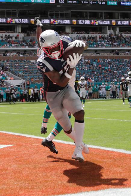 New England Patriots wide receiver Antonio Brown (17) scores a touchdown as Miami Dolphins corn ...