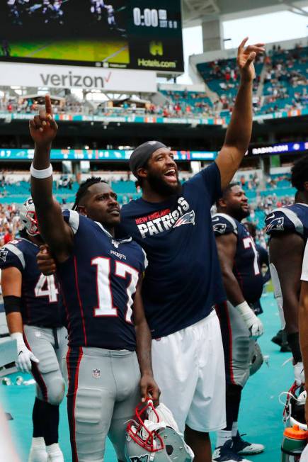 New England Patriots wide receiver Antonio Brown (17) and defensive end Deatrich Wise, celebrat ...