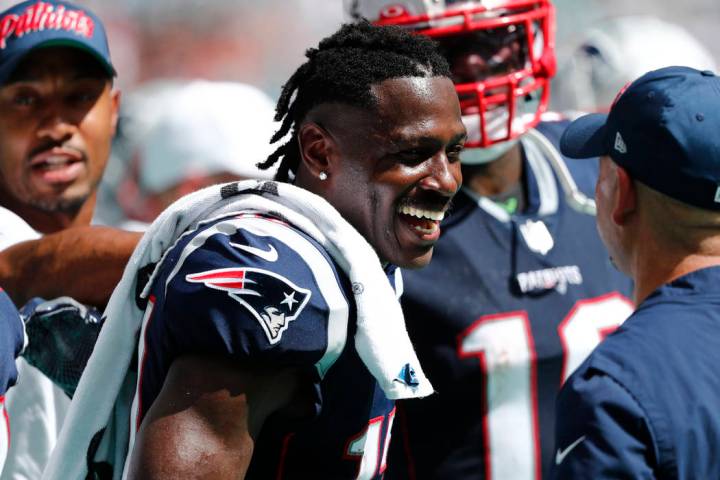 New England Patriots wide receiver Antonio Brown (17) smiles on the sidelines, during the secon ...