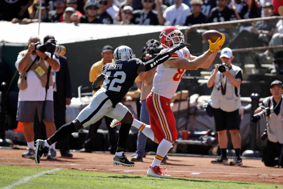 Kansas City Chiefs tight end Travis Kelce scores a touchdown as Oakland Raiders free safety Kar ...