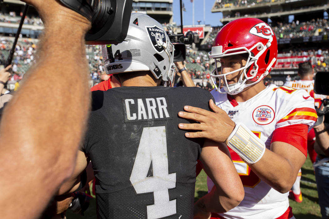 Kansas City Chiefs quarterback Patrick Mahomes, right, greets Oakland Raiders quarterback Derek ...