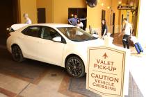 Hotel guests at Wynn Las Vegas prepare to load their luggage into their car at valet parking pi ...