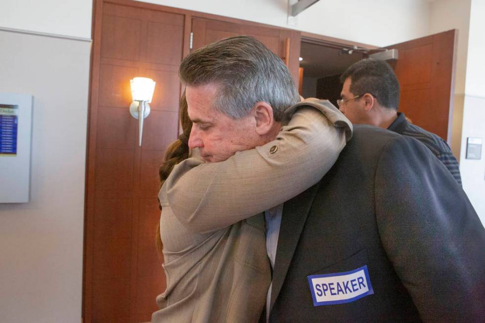 Retired Metro sergeant Steven Meriwether hugs Kelly Brewer after her son Alexander Brewer was s ...