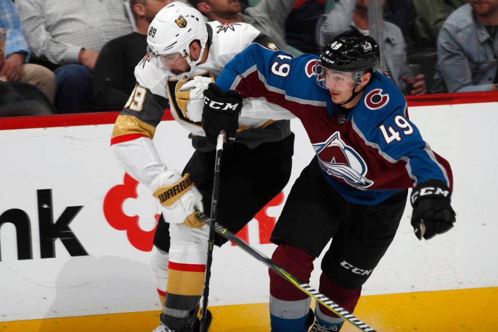 Colorado Avalanche defenseman Samuel Girard, right, fights to slow down Vegas Golden Knights ri ...