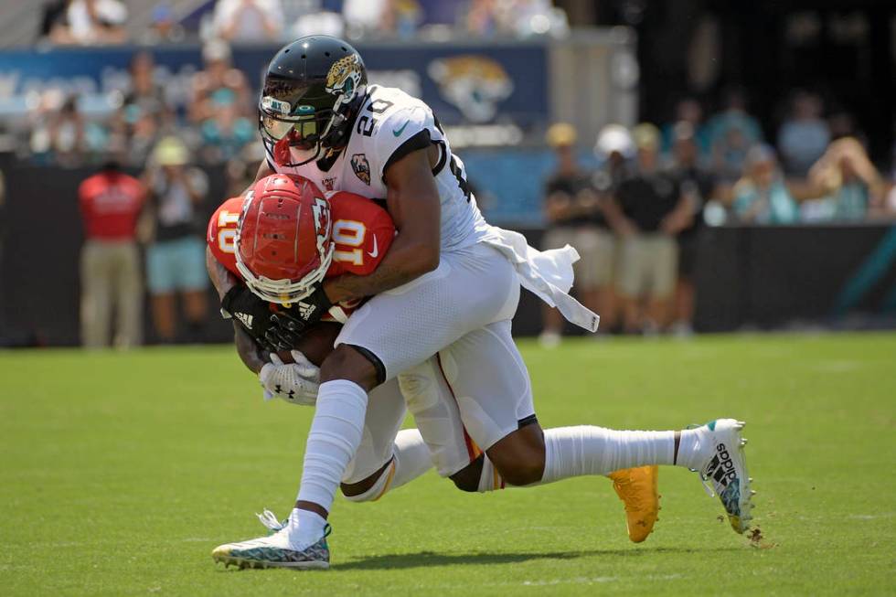 Kansas City Chiefs wide receiver Tyreek Hill (10) is stopped by Jacksonville Jaguars cornerback ...