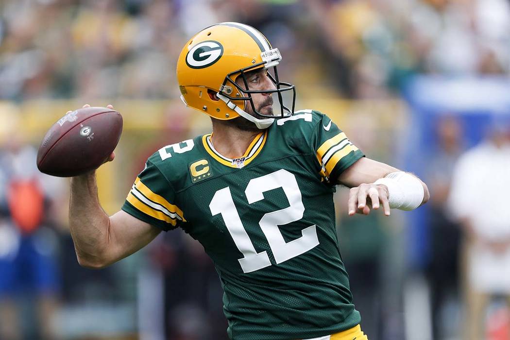 Green Bay Packers' Aaron Rodgers throws during the first half of an NFL football game against t ...