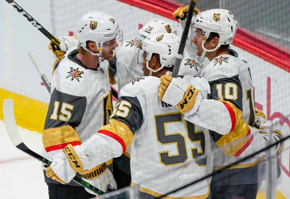 Vegas Golden Knights center Nicolas Roy (10) celebrates a goal with teammates Jon Merrill (15), ...