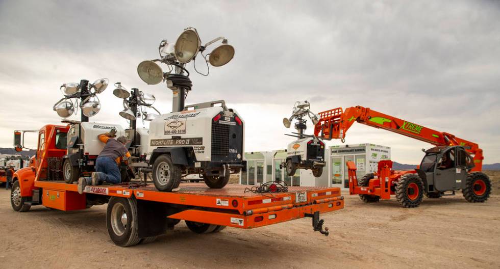 A crew with Ahern Rentals unloads equipment in the Area 51 Basecamp about the Alien Research Ce ...