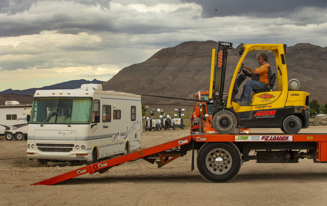 A crew with Ahern Rentals moves equipment in the Area 51 Basecamp about the Alien Research Cent ...