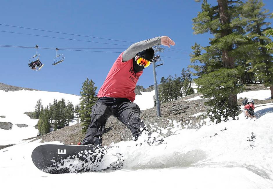 FILE - In this July 1, 2017 file photo, a snowboarder cuts throughout the snow at the Squaw Val ...