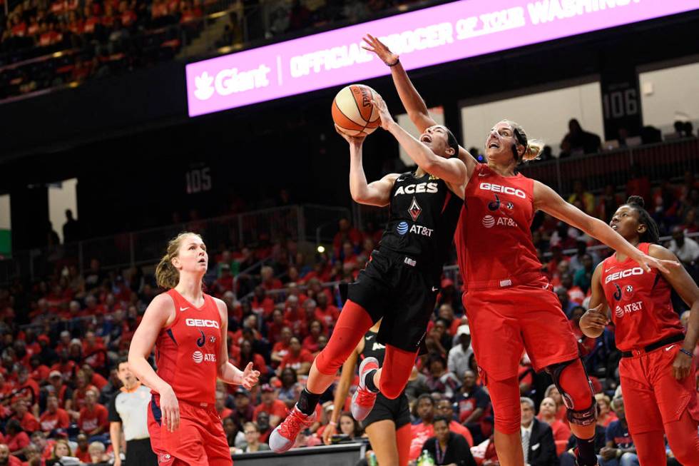 Las Vegas Aces guard Kelsey Plum, second from left, goes to the basket against Washington Mysti ...