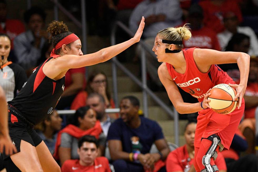 Las Vegas Aces forward Dearica Hamby, left, guards Washington Mystics forward Elena Delle Donne ...