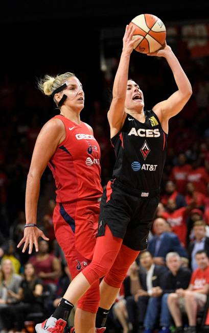 Las Vegas Aces guard Kelsey Plum throws up a shot in front of Washington Mystics forward Elena ...