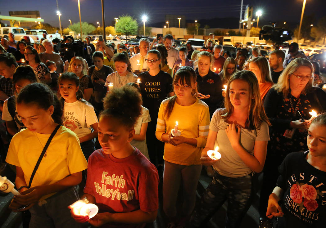 People gather at the Sobe Ice Arena during a candlelight vigil for Mark Garcia and his daughter ...