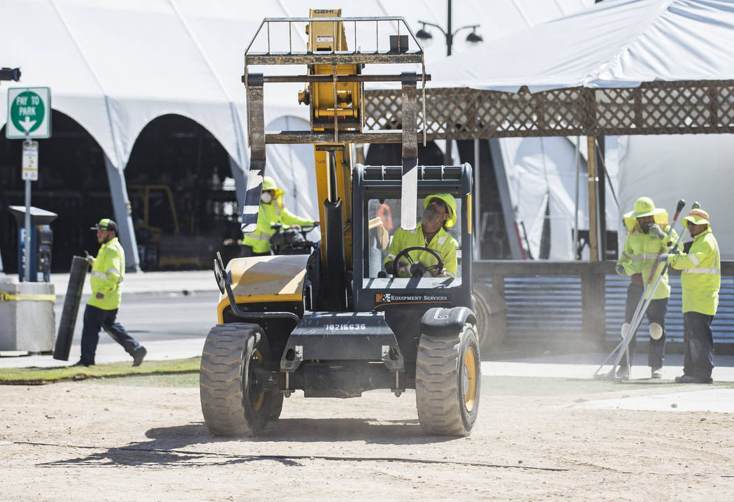 Construction workers install flooring at the intersection of South 8th Street and Fremont Stree ...