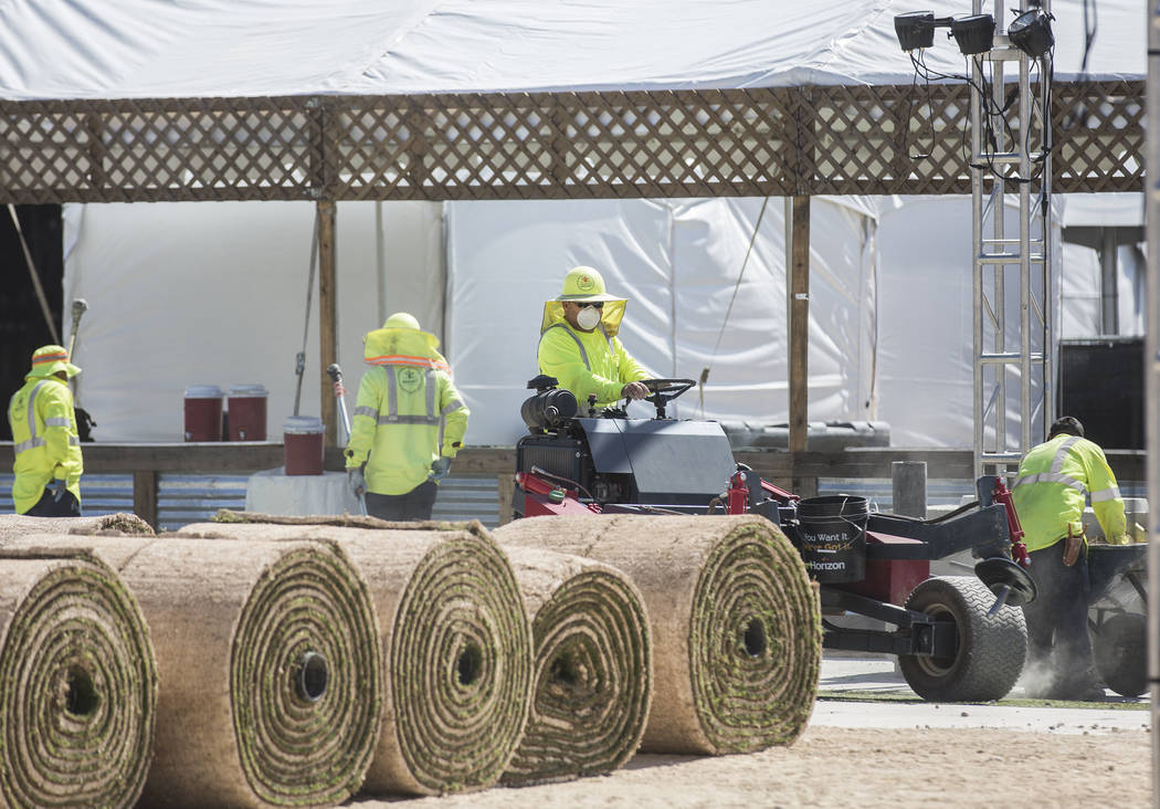 Construction workers install flooring at the intersection of South 8th Street and Fremont Stree ...