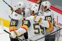 Vegas Golden Knights center Nicolas Roy (10) celebrates a goal with teammates Jon Merrill (15), ...