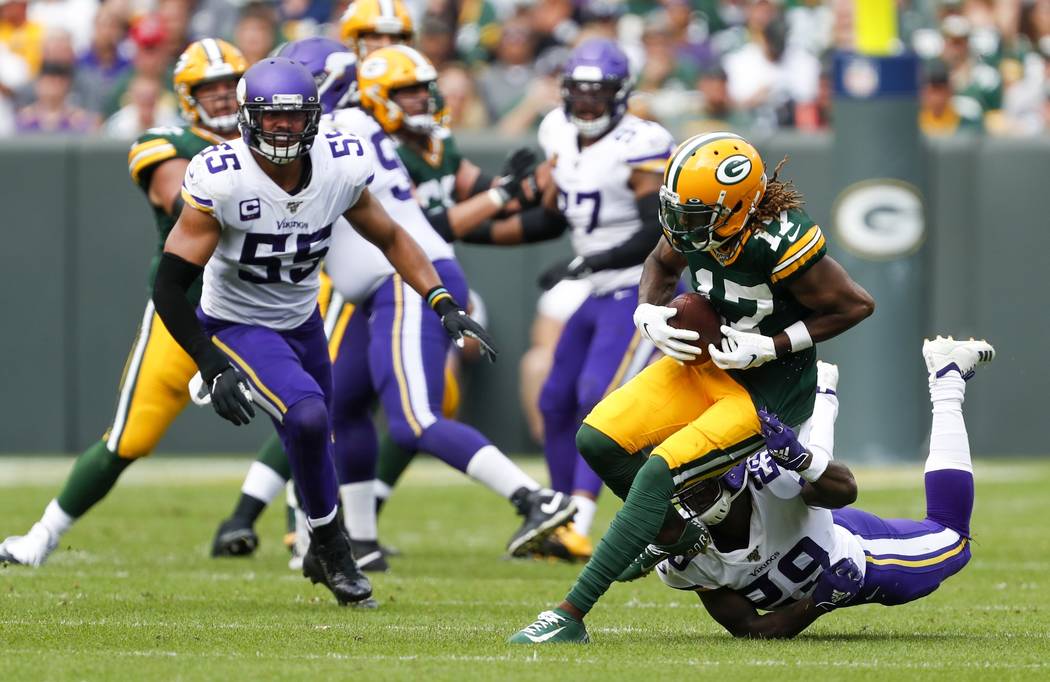Green Bay Packers' Davante Adams runs after catching a pass during the second half of an NFL fo ...