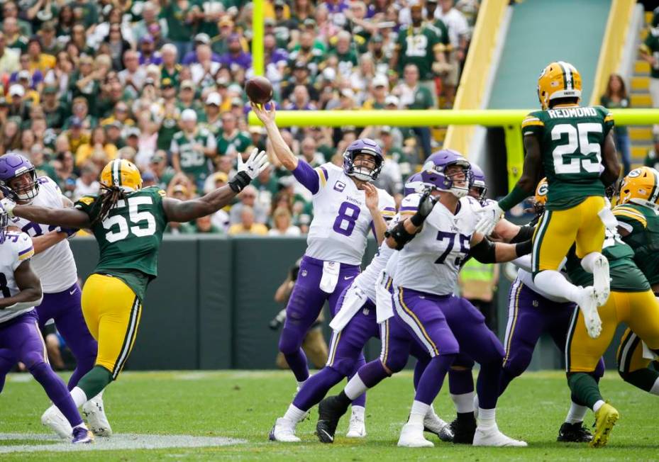 Minnesota Vikings' Kirk Cousins throws during the second half of an NFL football game against t ...