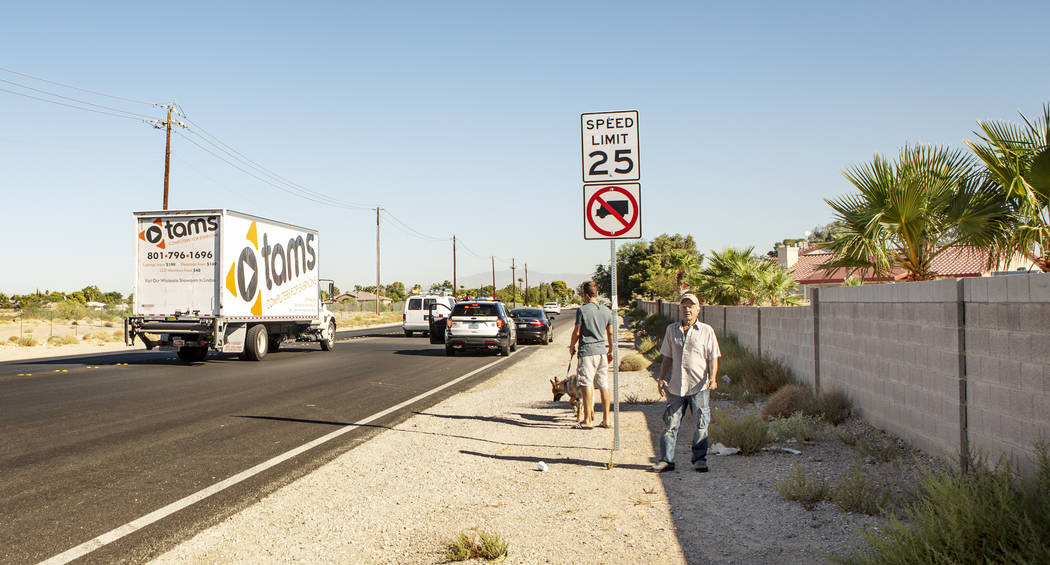 A truck driver drives thru a no-trucks zone on South Valley View Boulevard as an officer pulls ...