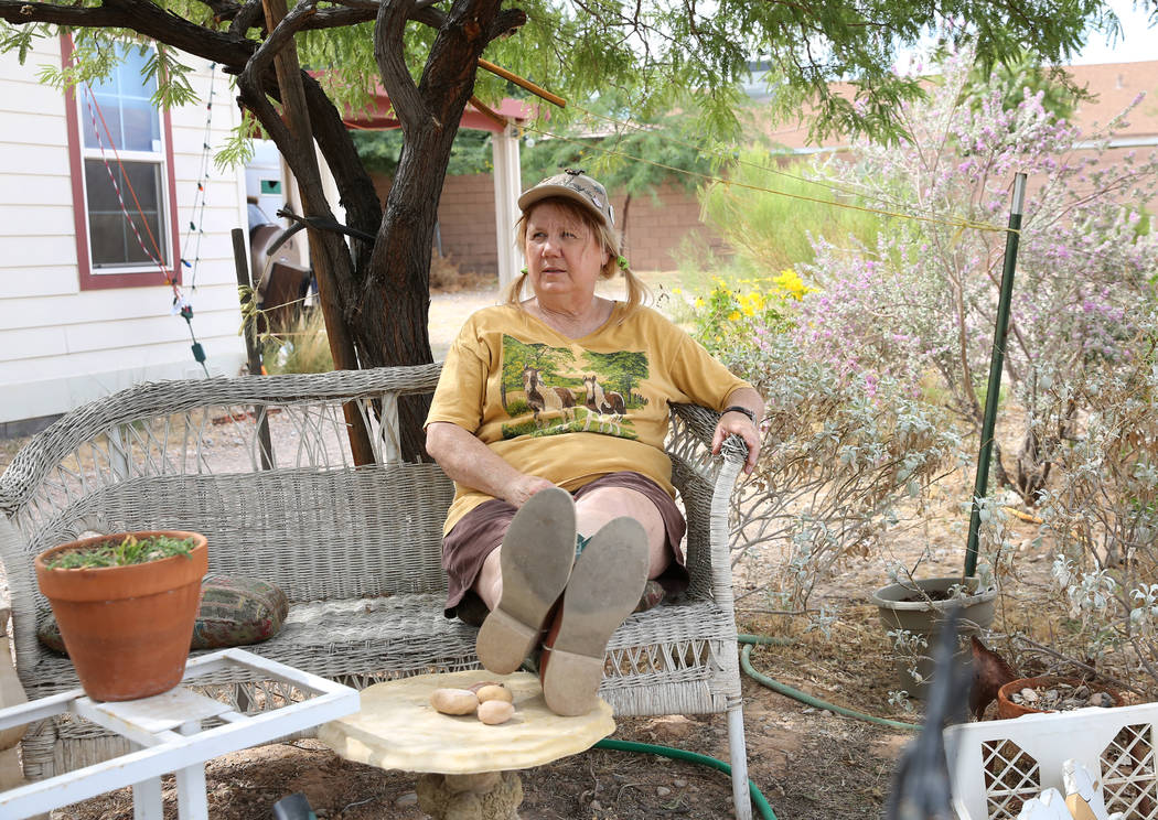 Susan Lorenz, 62, relaxes in the garden of her home at Warm Springs Road and Decatur Boulevard ...
