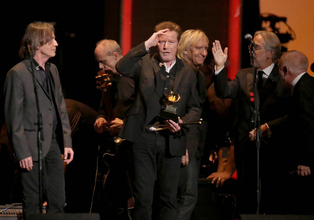 Don Henley, center, holds The Eagles' 1978 Grammy award for record of the year for “Hote ...