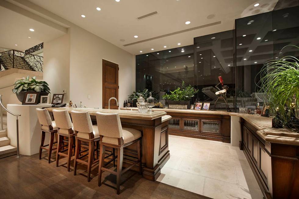 There is a large bar on the first level. (Synergy Sotheby’s International Realty)