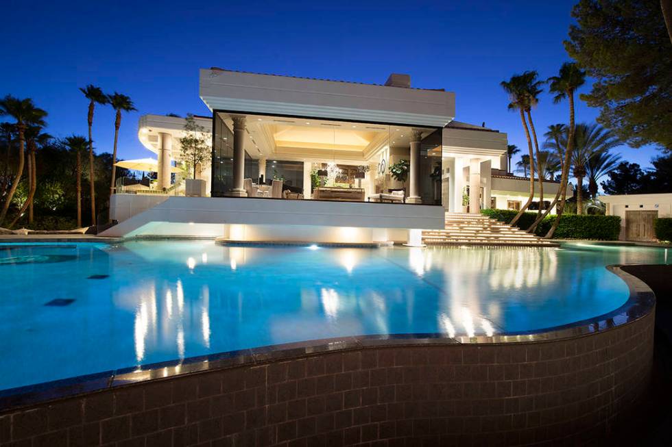 The large pool flows to the side of the home. (Synergy Sotheby’s International Realty)