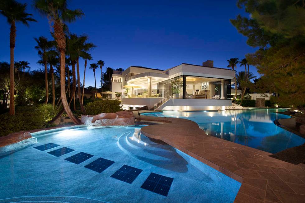 The estate features a large pool with a walkway. (Synergy Sotheby’s International Realty)