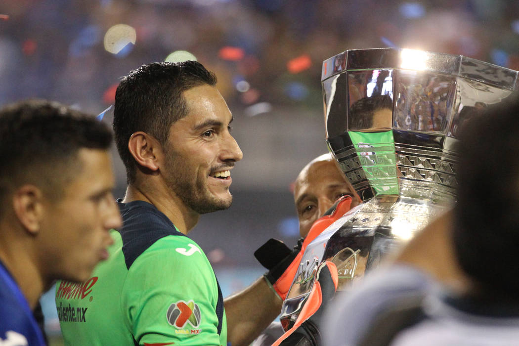 Cruz Azul's Jesus Corona (1) holds up the trophy after his team's win 2-1 against Tigres in the ...