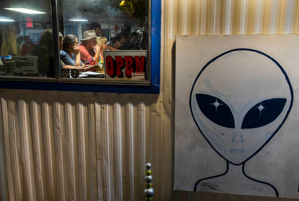 Customers sit at the bar in the Little A'Le'Inn as the Alienstock festival grows near on Wednes ...