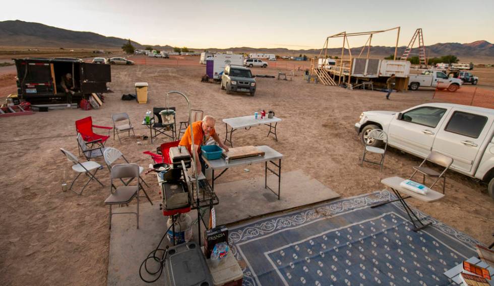 George Morrow readies the site about his camper for serving breakfast to the stage construction ...