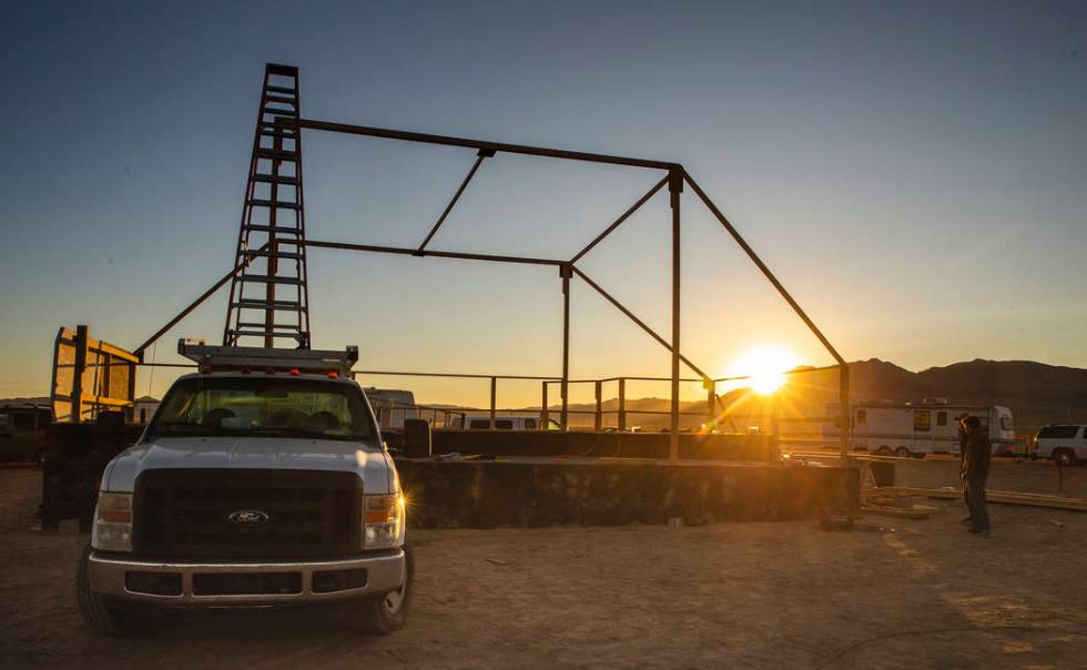 The sun comes up on the main stage while the construction crew begins to stir as the start of t ...