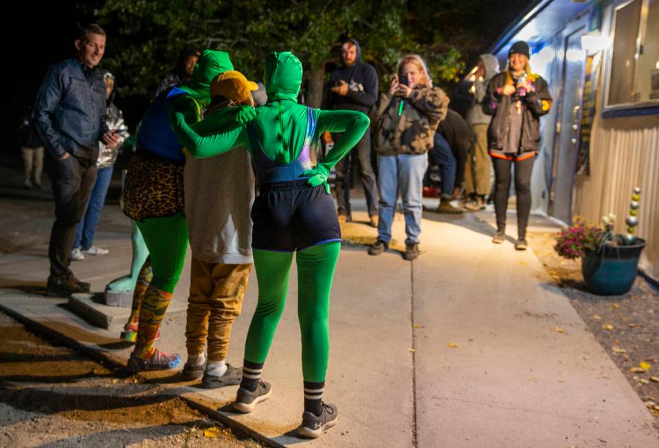 Festivalgoers hang out with some aliens at the Little A'Le'Inn late on the first night of Alien ...