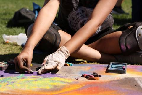 Gabby Antonio works on her chalk art in part of Chalk and Cheers at Skye Canyon Park in Las Veg ...