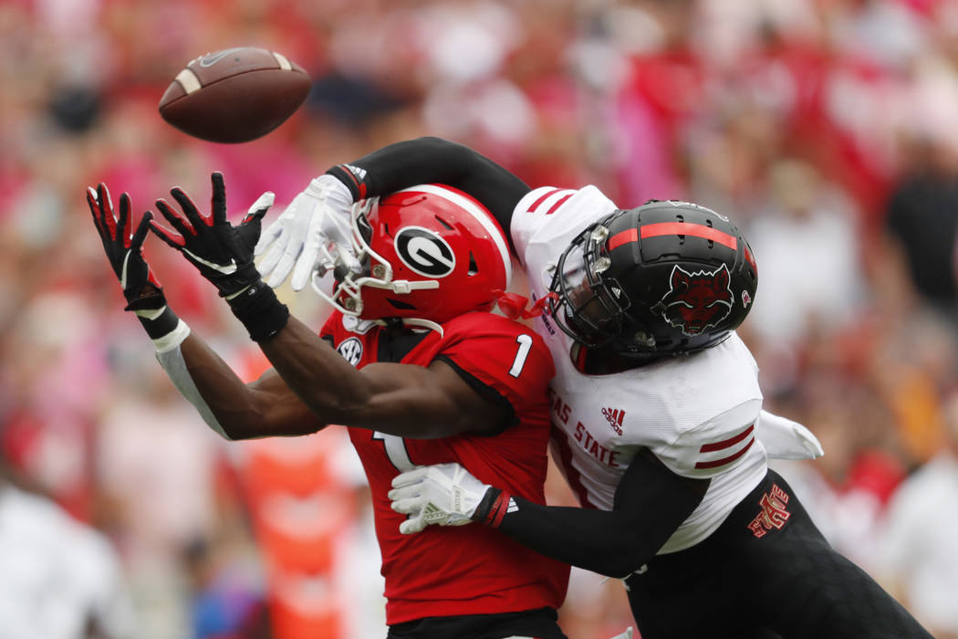 Arkansas State cornerback Jerry Jacobs, right, breaks up a pass intended for Georgia wide recei ...