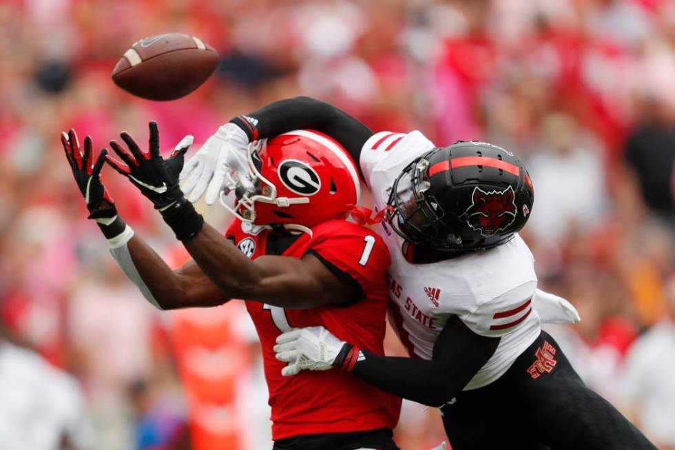 Arkansas State cornerback Jerry Jacobs, right, breaks up a pass intended for Georgia wide recei ...