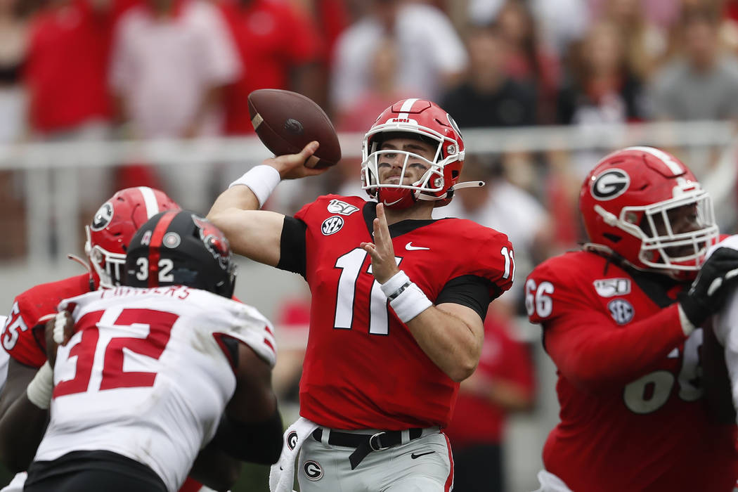 Georgia quarterback Jake Fromm (11) throws from the pocket in the first half of an NCAA college ...