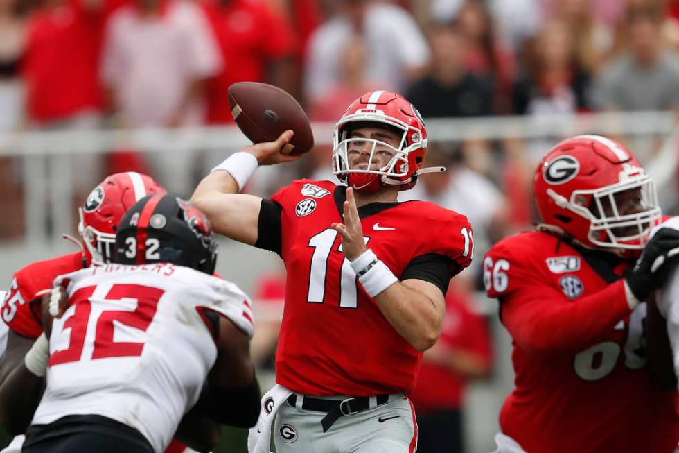 Georgia quarterback Jake Fromm (11) throws from the pocket in the first half of an NCAA college ...