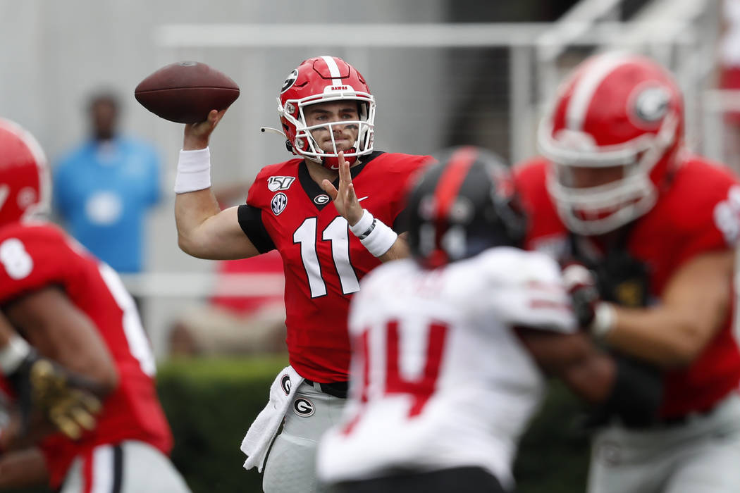 Georgia quarterback Jake Fromm (11) throw from the pocket against Arkansas State in the first h ...