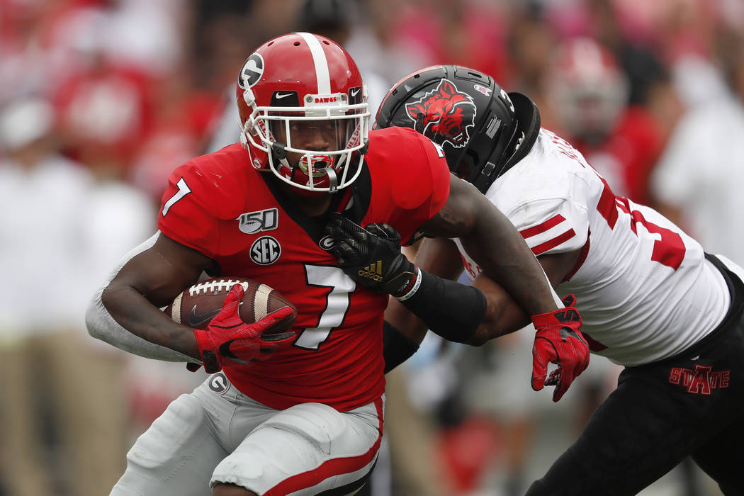 Georgia running back D'Andre Swift (7) is tackled by Arkansas State defensive back Darreon Jack ...