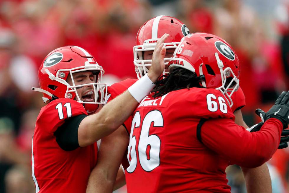 Georgia quarterback Jake Fromm (11) celebrates with offensive lineman Solomon Kindley (66) afte ...