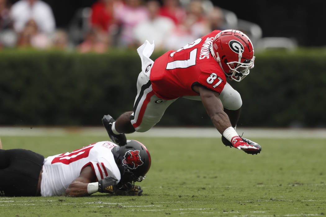 Georgia wide receiver Tyler Simmons (87) is stopped by Arkansas State defensive back Detravion ...