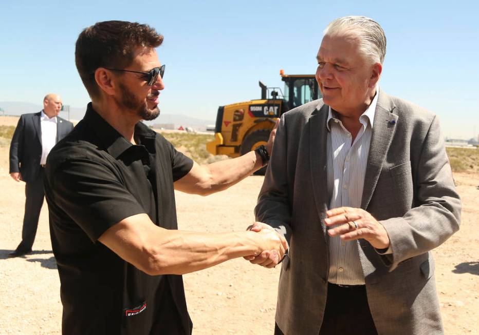 Switch CEO Rob Roy, left, shakes hands with Nevada Gov. Steve Sisolak during a ceremonial groun ...