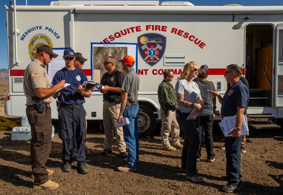 Emergency personnel confer while beginning to man the Incident Command Post in the Tikaboo Vall ...