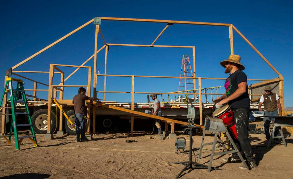 Wily Savage lead singer Alon Burton plays a conga drum as the construction crew begins work on ...