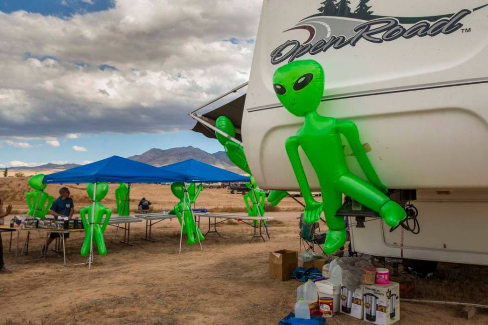 Aliens hang on a merchandise and supply tent as the start of the Alienstock festival nears on T ...